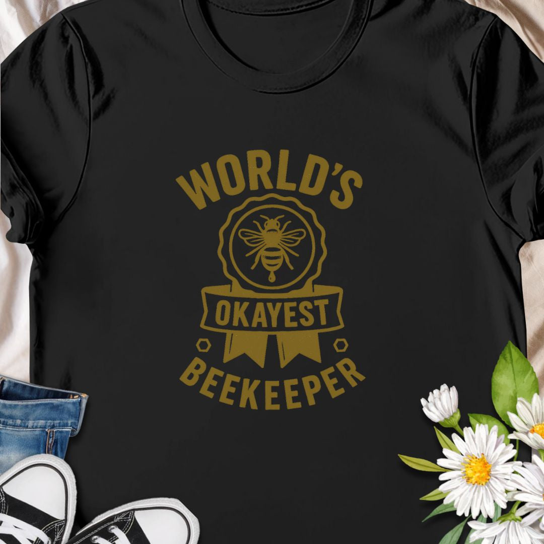 Celebrate your love for beekeeping with a humorous twist in this "World's Okayest Beekeeper" T-Shirt. Perfect for backyard beekeepers, honey lovers, and bee enthusiasts who know it's not about perfection—it's about passion. Makes a great gift for bee dads, moms, hobbyists, and anyone who keeps buzzing through life.