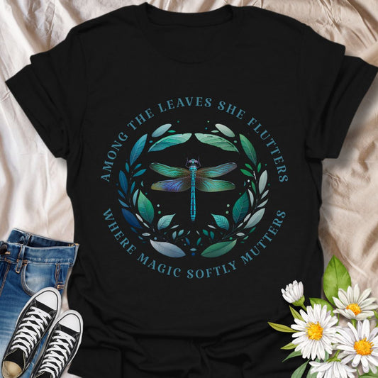 Mystical dragonfly t-shirt with detailed wings and a leafy circle, wrapped in the phrase “Among the leaves she flutters, where magic softly mutters.” A magical nature design for dreamers, woodland lovers, and poetic souls.