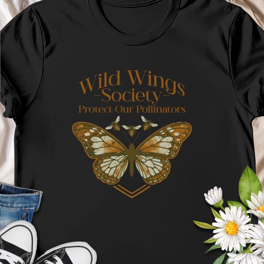 Butterfly conservation themed shirt with 'Wild Wings Society' design. Great for nature lovers and pollinator protectors.   Soft, worn-in comfort meets quiet activism - a warm-toned monarch rests at the center of a vintage-inspired crest, with the words “Wild Wings Society — Protect Our Pollinators” arched above. 