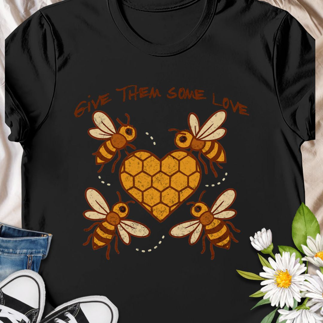 Show your support for the bees with this adorable “Give Them Some Love” t-shirt featuring four cartoon bees buzzing around a heart-shaped honeycomb. It’s the perfect nature-inspired shirt for bee lovers, pollinator advocates, and environmentalists. A sweet way to spread awareness and style!