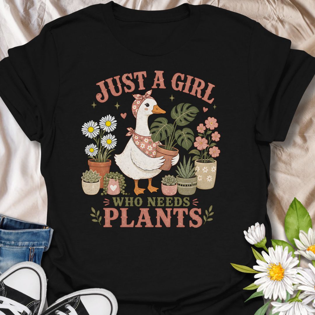 This Just A Girl Who Needs Plants t-shirt is made for plant lovers who know leafy friends, flowers, and a little garden time can fix almost anything. Featuring a sweet goose holding a potted monstera, surrounded by daisies, succulents, flowering plants, hearts, and soft botanical details, this design has a cute cottagecore-inspired feel. Perfect for plant moms, gardeners, houseplant collectors, flower fans, and anyone who proudly needs more plants in their life.