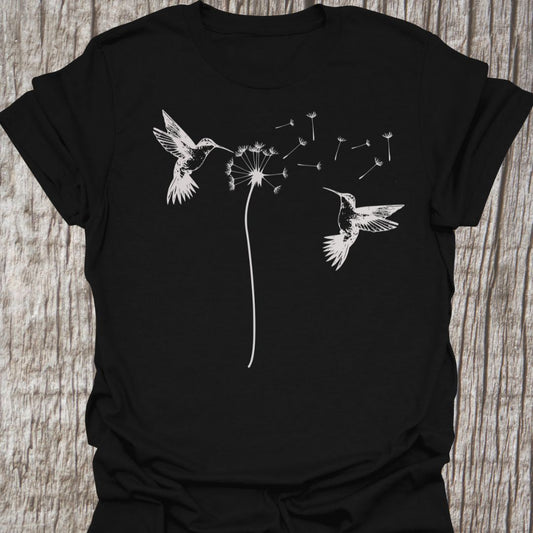 Two humming birds hovering at Dandelion in white on black t-shirt