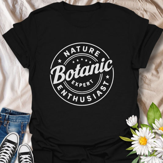 Show off your love for plants with this bold graphic t-shirt featuring the phrase "Nature Expert  Botanic Enthusiast." This is in either white or black text, dependant on the color choice.  This Tee is Perfect for gardeners, plant parents, and anyone passionate about botany, nature, and green living.