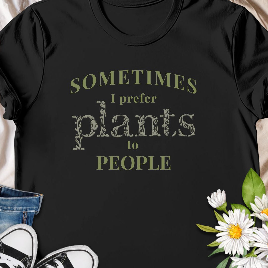 This tee speaks to the plant-lover who finds calm in soil, leaves, and slow-growing routines. The muted, nature-toned print reads “Sometimes I prefer plants to people,” a little wry and wholly relatable. Wear it while tending a crowded windowsill, carrying new finds home from the nursery, or lounging with a book as your succulents soak up afternoon light. 