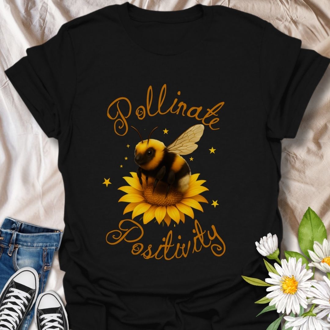 Pollinate Positivity t-shirt featuring a cute bumblebee on a bright sunflower, spreading good vibes and positive energy. Perfect bee lover shirt, nature-inspired graphic tee, gardening gift, or summer aesthetic outfit. Soft, lightweight, and ideal for women, teens, or anyone who loves bees, sunflowers, and inspirational quotes
