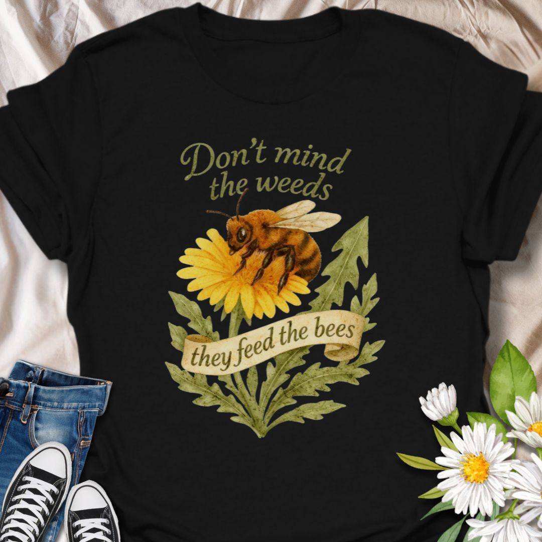 Support pollinators in style with this charming “Don’t Mind the Weeds, They Feed the Bees” t-shirt. Featuring a hand-drawn bee and dandelion artwork, this eco-friendly message tee is perfect for gardeners, nature lovers, and bee advocates who know weeds can be beautiful too.