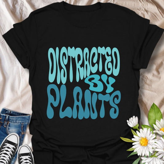 Fun "Distracted By Plants" t-shirt with bold retro typography in vibrant teal. Perfect for plant lovers, gardeners, and nature enthusiasts. Great gift idea for plant moms, gardeners, or anyone obsessed with houseplants, succulents, or botanical style.