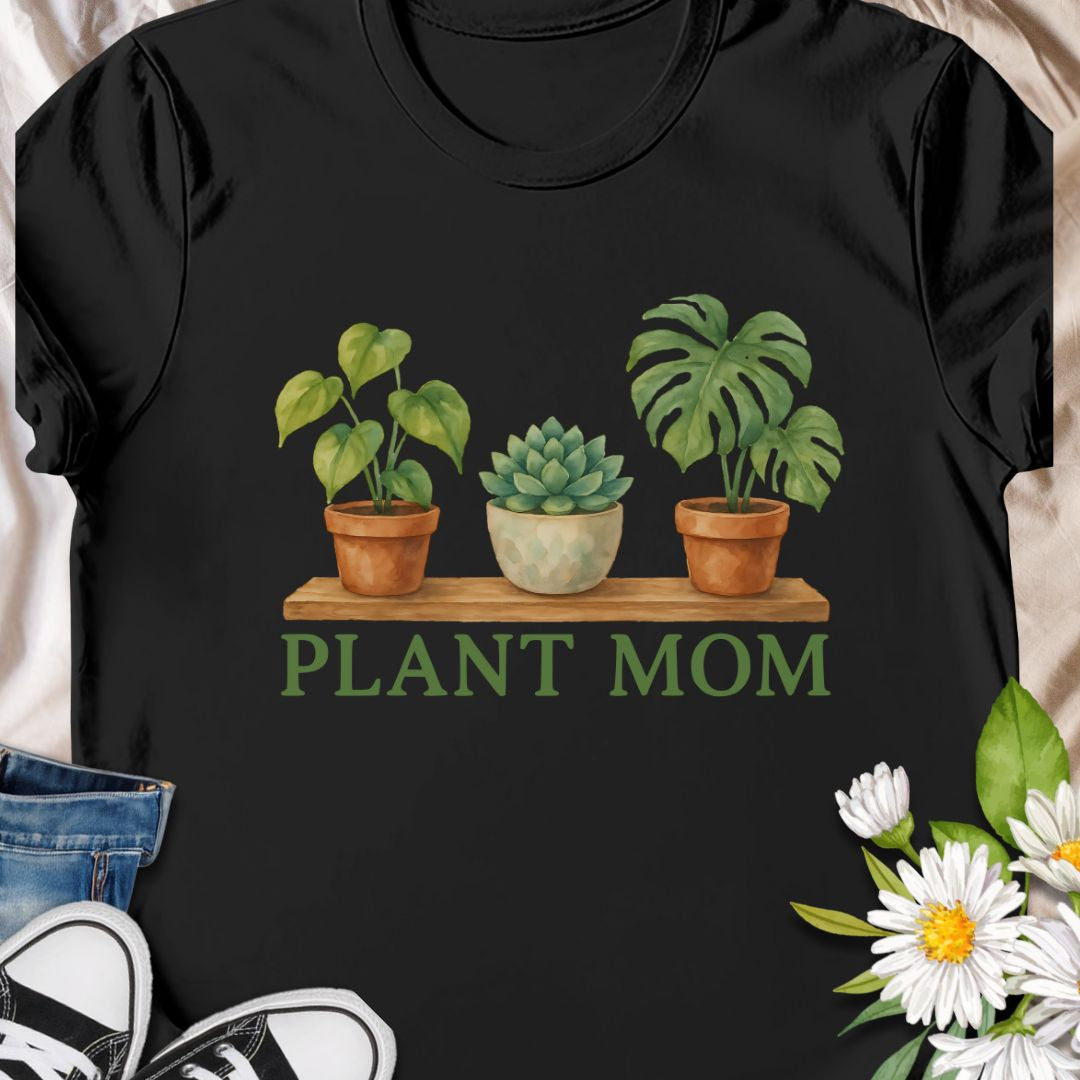 Show off your green thumb with this charming “Plant Mom” t-shirt featuring potted plants on a wooden shelf. Ideal for plant lovers, indoor gardeners, or anyone who adores succulents and tropical houseplants. This tee makes a perfect gift for Mother's Day, birthdays, or just to treat yourself with botanical flair.