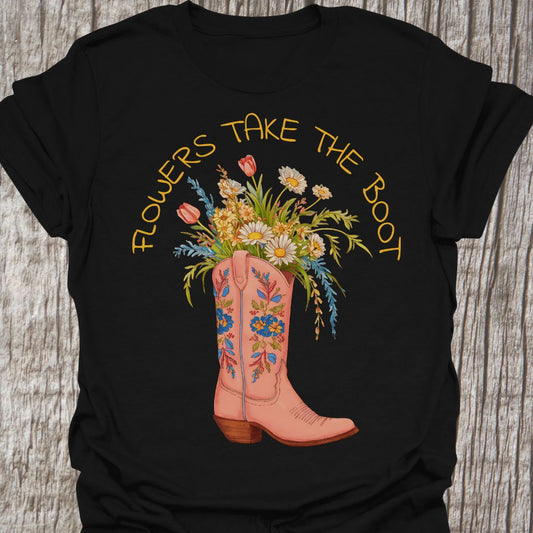 Flowers Take The Boot - Black t-shirt featuring a pink boot with flowers emerging from it. The boot also has a floral design.
