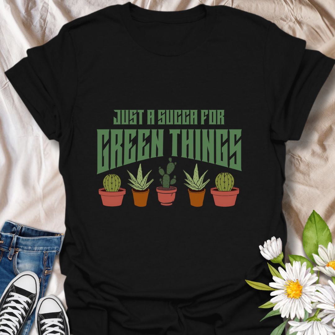 Embrace your love for all things leafy with this playful “Just a Succa for Green Things” t-shirt. Featuring a lineup of adorable potted succulents and bold retro typography, it’s perfect for plant lovers with a sense of humor.