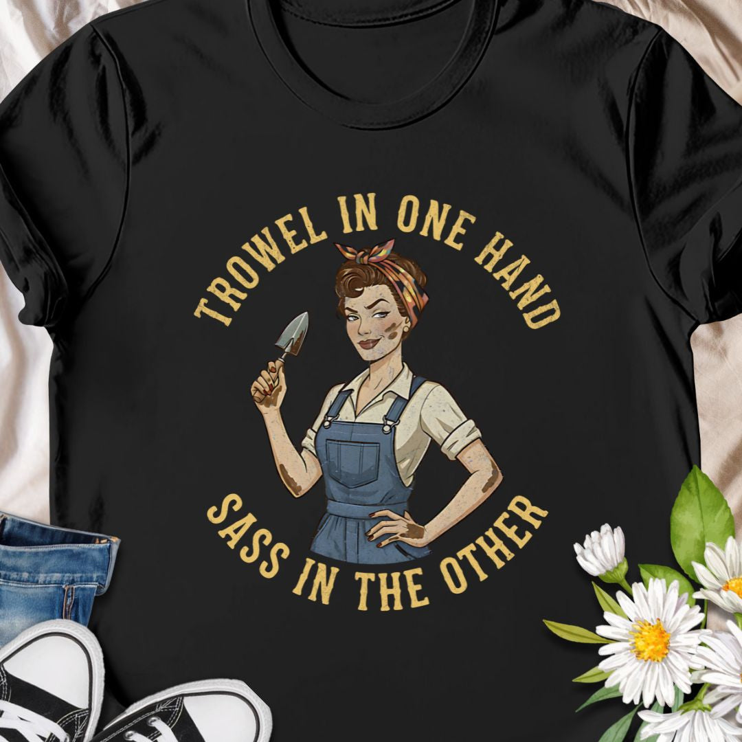 A bold, vintage-inspired gardening t-shirt featuring the phrase “Trowel in One Hand, Sass in the Other.” Perfect for confident gardeners, plant moms, and anyone who loves humor, dirt, and a little attitude in the garden.