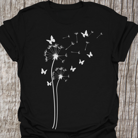 Flower with petals blowing in the breeze.  These are interspersed with butterflies in a silhouette style.  Print is in white on a black t-shirt.