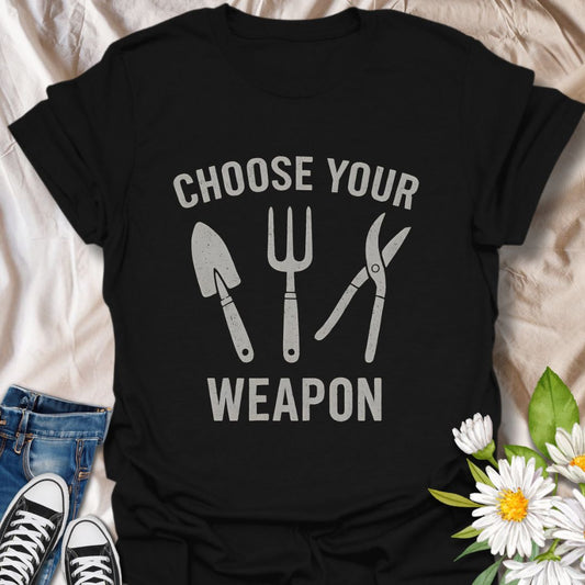 Bold and witty gardening t-shirt featuring hand tools with the phrase “Choose Your Weapon.” Perfect for passionate gardeners who treat digging, pruning, and planting like a true mission. A fun gift for green thumbs and outdoor warriors.