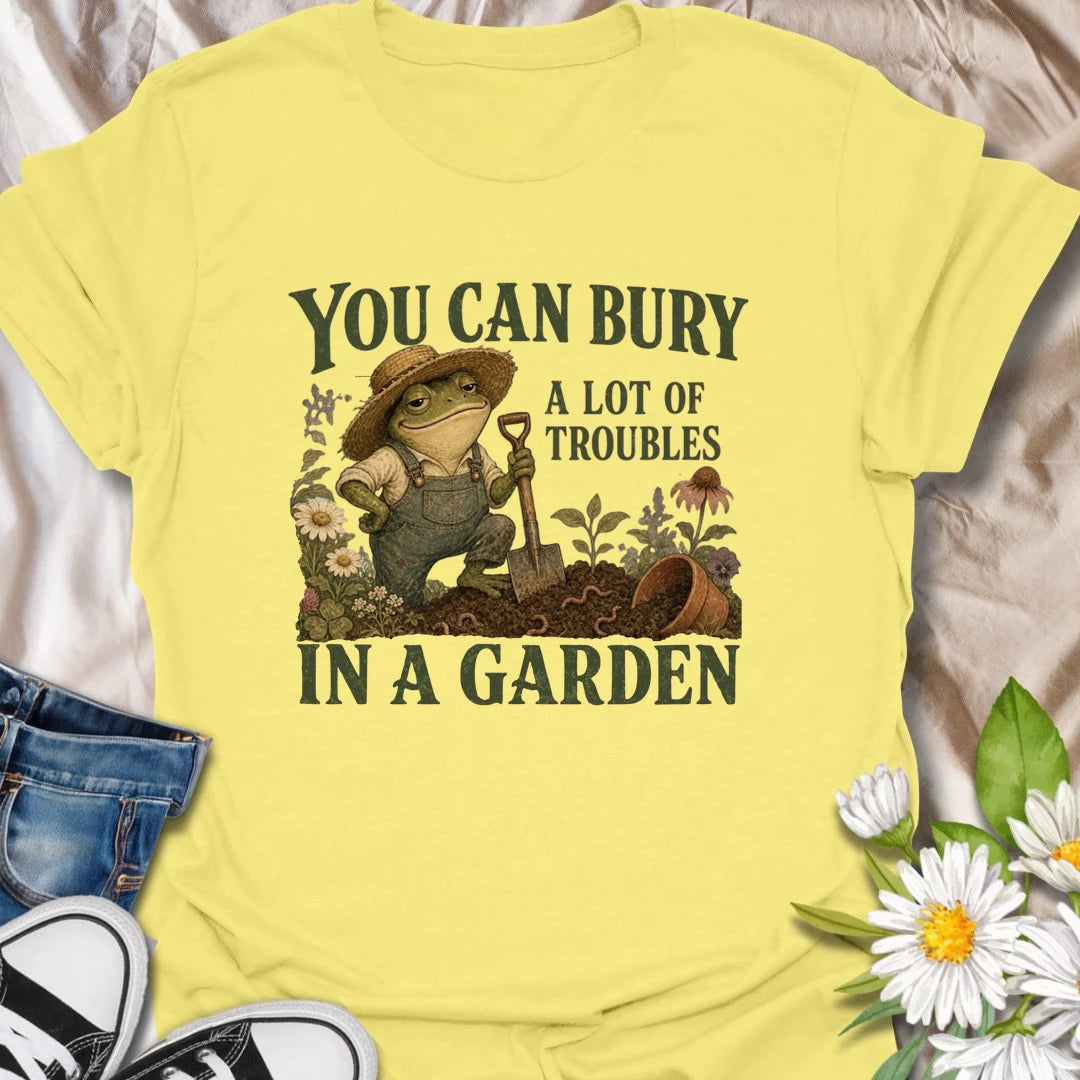 Funny gardening t-shirt with a charming frog and the classic saying about burying troubles in a garden.
Features vintage-style garden art with flowers, rich soil, and a playful frog gardener holding a shovel.
A great gift for gardeners, frog lovers, flower lovers, and anyone who finds peace and humor in the garden.