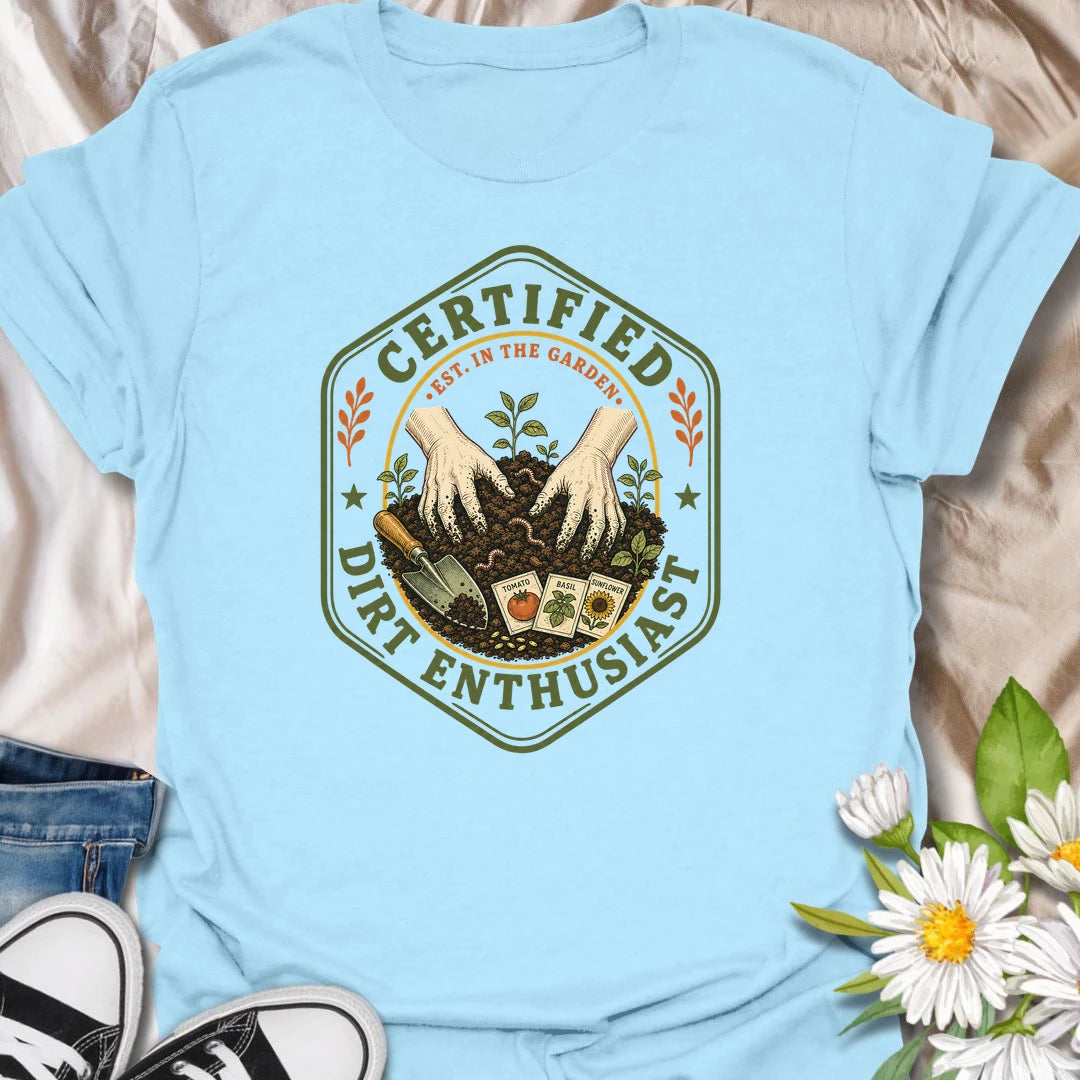This Certified Dirt Enthusiast t-shirt is made for gardeners who are happiest with their hands in the soil and seedlings ready to grow. Featuring a vintage badge-style design with gloved hands, rich garden dirt, seed packets, tools, and fresh sprouts, this tee has a classic gardening-club feel with plenty of earthy personality. Perfect for gardeners, plant lovers, backyard growers, vegetable gardeners, flower fans, and anyone who proudly loves dirt, seeds, and garden time.