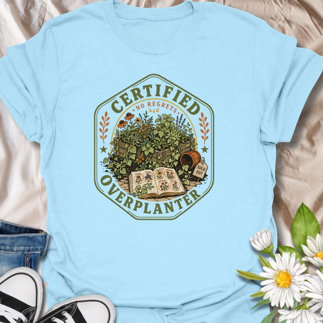 This Certified Overplanter t-shirt is made for gardeners who know there is always room for just one more seedling, even when the garden is already overflowing. Featuring a vintage badge-style design with crowded garden beds, seed packets, an open seed catalog, a sold out pot, and the phrase No Regrets, this tee has a funny plant-lover feel with classic garden-club charm. Perfect for gardeners, plant lovers, backyard growers, flower fans, vegetable gardeners, and anyone who proudly overplants every season.