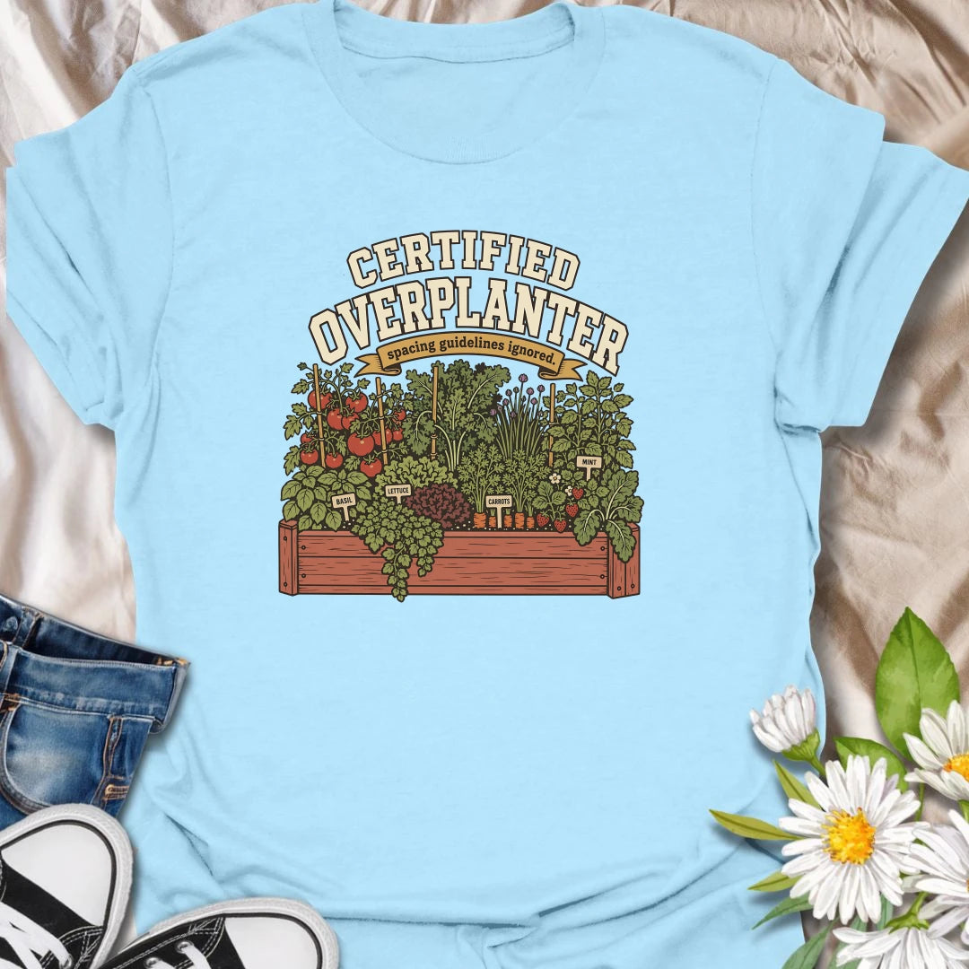 Celebrate an overflowing vegetable garden with this “Certified Overplanter” T-shirt. The detailed raised-bed design features tomatoes, carrots, lettuce, basil, mint, strawberries, and the perfect lack of spacing. It is a funny gift for ambitious gardeners who always squeeze in one more plant.
