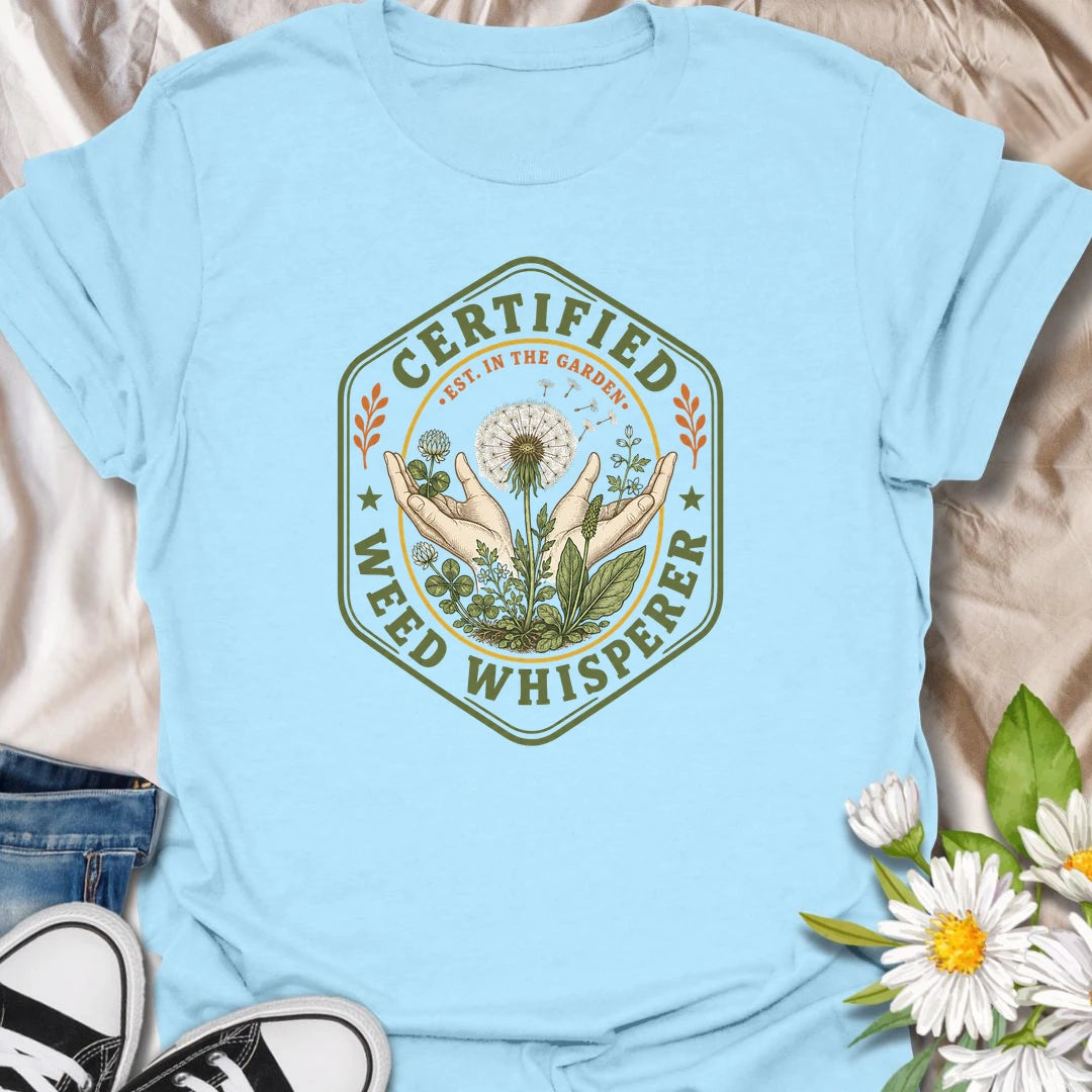 This Certified Weed Whisperer t-shirt is made for gardeners who somehow have a special talent for growing weeds whether they meant to or not. Featuring a vintage badge-style design with hands, dandelions, leafy weeds, garden details, and bold certified lettering, this tee has a funny plant-lover feel with classic garden-club charm. Perfect for gardeners, plant lovers, beginner gardeners, backyard growers, wildflower fans, and anyone whose weeds are thriving beautifully.