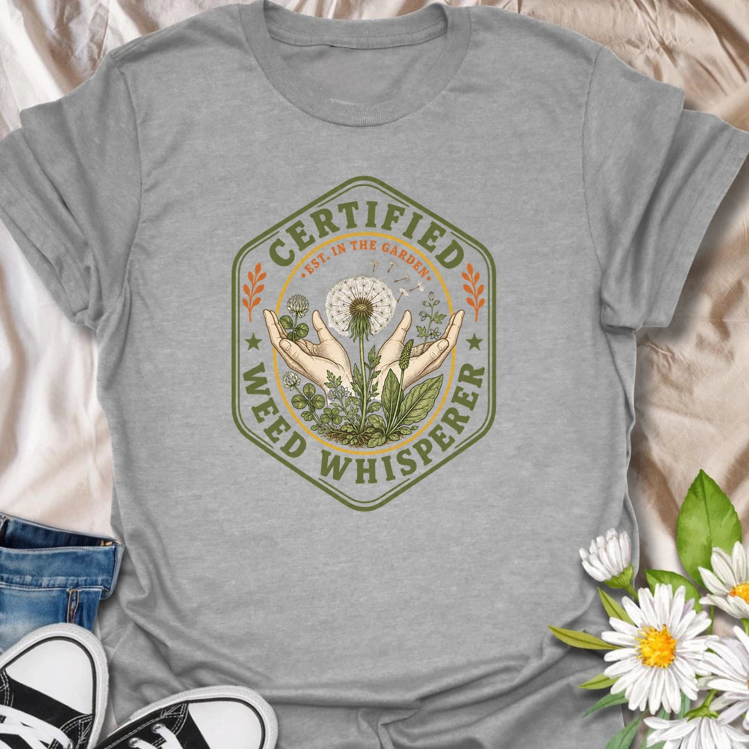 This Certified Weed Whisperer t-shirt is made for gardeners who somehow have a special talent for growing weeds whether they meant to or not. Featuring a vintage badge-style design with hands, dandelions, leafy weeds, garden details, and bold certified lettering, this tee has a funny plant-lover feel with classic garden-club charm. Perfect for gardeners, plant lovers, beginner gardeners, backyard growers, wildflower fans, and anyone whose weeds are thriving beautifully.