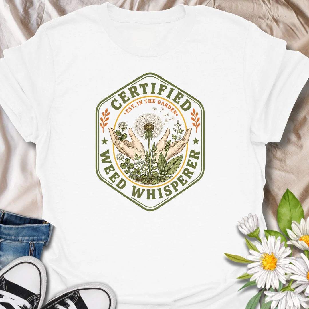This Certified Weed Whisperer t-shirt is made for gardeners who somehow have a special talent for growing weeds whether they meant to or not. Featuring a vintage badge-style design with hands, dandelions, leafy weeds, garden details, and bold certified lettering, this tee has a funny plant-lover feel with classic garden-club charm. Perfect for gardeners, plant lovers, beginner gardeners, backyard growers, wildflower fans, and anyone whose weeds are thriving beautifully.