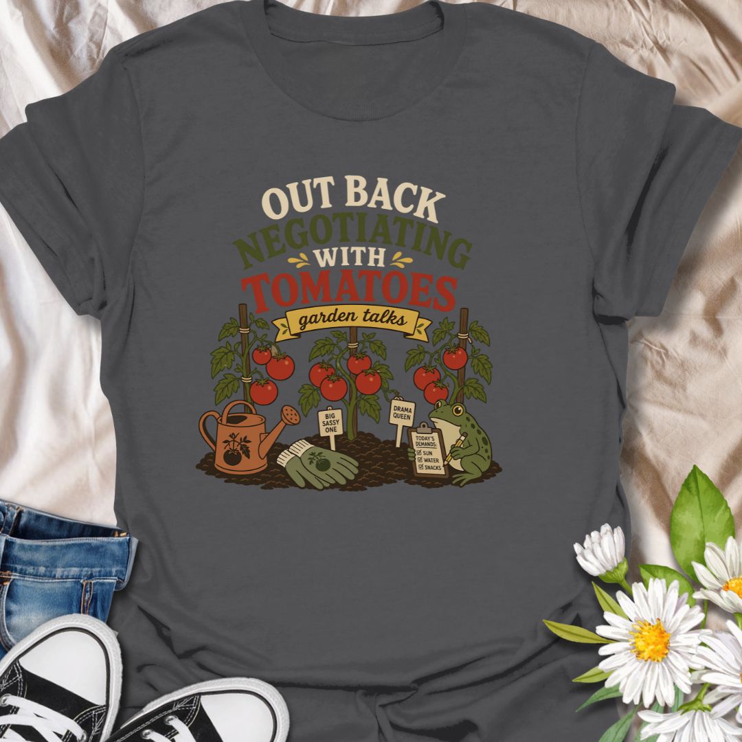 A funny vegetable gardening T-shirt for anyone who spends time discussing terms with their tomato plants. The design features ripe tomatoes, garden tools, plant stakes, and a frog recording the plants’ demands. A playful gift for tomato growers, backyard gardeners, and vegetable garden enthusiasts