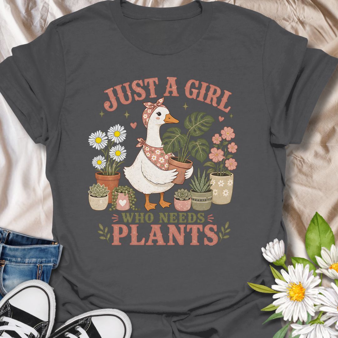 This Just A Girl Who Needs Plants t-shirt is made for plant lovers who know leafy friends, flowers, and a little garden time can fix almost anything. Featuring a sweet goose holding a potted monstera, surrounded by daisies, succulents, flowering plants, hearts, and soft botanical details, this design has a cute cottagecore-inspired feel. Perfect for plant moms, gardeners, houseplant collectors, flower fans, and anyone who proudly needs more plants in their life.