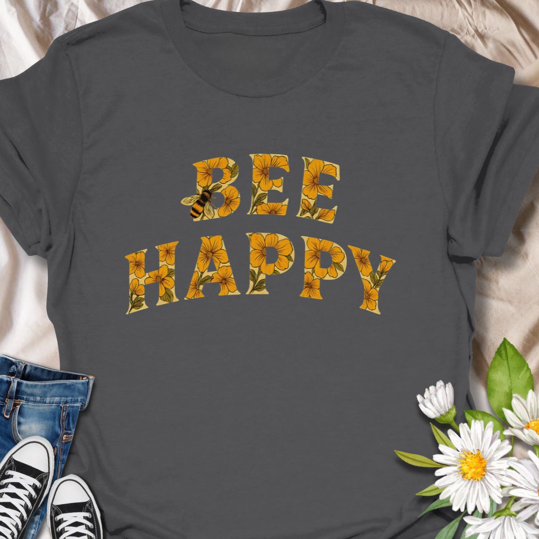 Spread positivity and nature-loving vibes with this charming “Bee Happy” t-shirt, featuring sunflower-filled typography and a playful bee motif. Perfect for beekeepers, garden lovers, and anyone who appreciates cheerful, nature-inspired fashion. A great gift for pollinator advocates and flower enthusiasts.