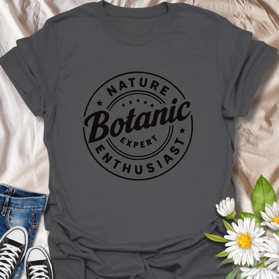 Show off your love for plants with this bold graphic t-shirt featuring the phrase "Nature Expert  Botanic Enthusiast." This is in either white or black text, dependant on the color choice.  This Tee is Perfect for gardeners, plant parents, and anyone passionate about botany, nature, and green living.