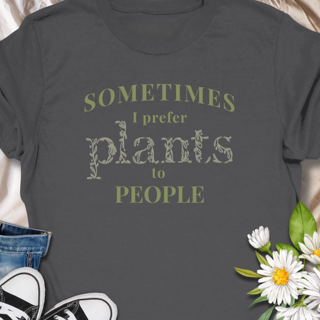 This tee speaks to the plant-lover who finds calm in soil, leaves, and slow-growing routines. The muted, nature-toned print reads “Sometimes I prefer plants to people,” a little wry and wholly relatable. Wear it while tending a crowded windowsill, carrying new finds home from the nursery, or lounging with a book as your succulents soak up afternoon light. 