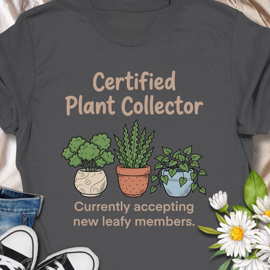 Show off your green thumb with this “Certified Plant Collector” t-shirt featuring charming potted plants and the phrase “Currently accepting new leafy members.” Perfect for plant parents, indoor jungle enthusiasts, or anyone who can’t resist bringing home another plant. A cozy and fun gift for birthdays or plant swaps.