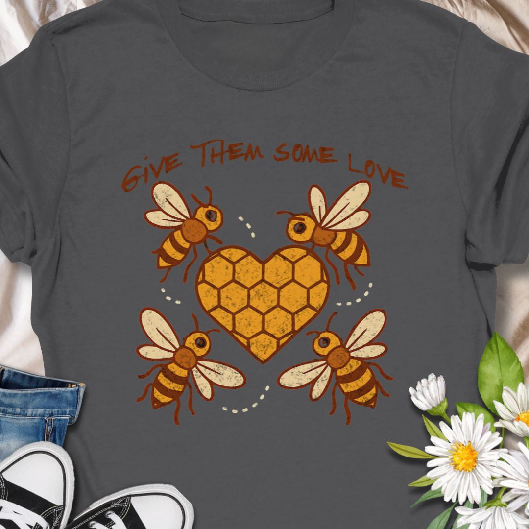 Show your support for the bees with this adorable “Give Them Some Love” t-shirt featuring four cartoon bees buzzing around a heart-shaped honeycomb. It’s the perfect nature-inspired shirt for bee lovers, pollinator advocates, and environmentalists. A sweet way to spread awareness and style!