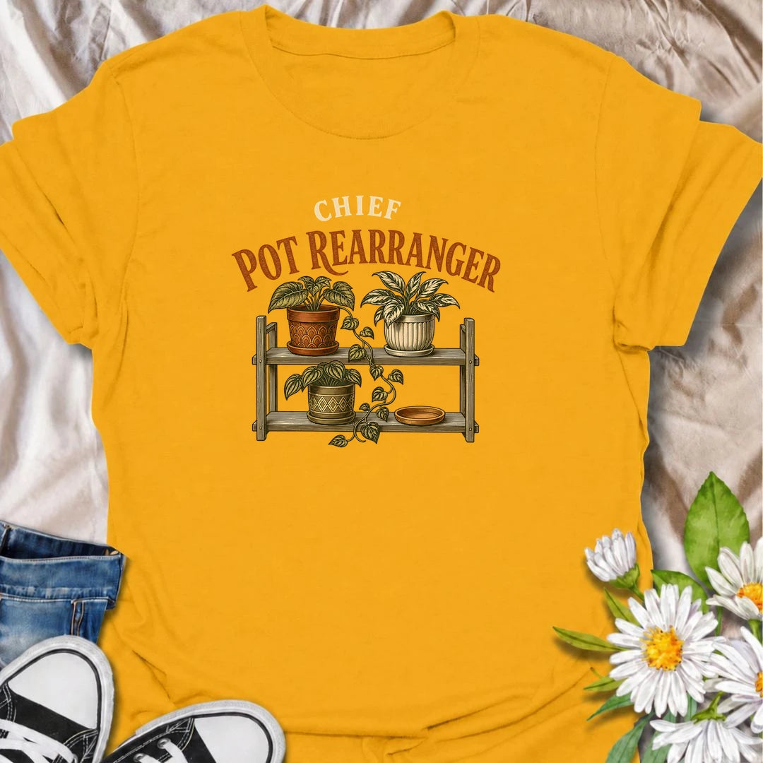 A funny houseplant T-shirt for anyone who can never leave the pots where they are for very long. Featuring a vintage-style plant shelf with patterned pots and trailing greenery, this design is perfect for plant parents who are constantly shifting, styling, and reorganizing their collection. The phrase “Chief Pot Rearranger” captures the familiar habit of moving plants around until everything feels just right. It makes a great gift for houseplant lovers, indoor gardeners, and anyone who treats plant shelves 