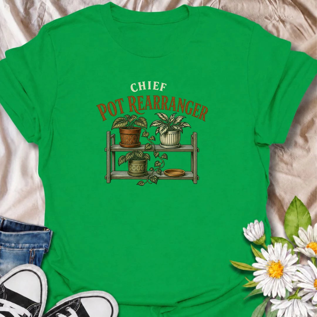 A funny houseplant T-shirt for anyone who can never leave the pots where they are for very long. Featuring a vintage-style plant shelf with patterned pots and trailing greenery, this design is perfect for plant parents who are constantly shifting, styling, and reorganizing their collection. The phrase “Chief Pot Rearranger” captures the familiar habit of moving plants around until everything feels just right. It makes a great gift for houseplant lovers, indoor gardeners, and anyone who treats plant shelves 