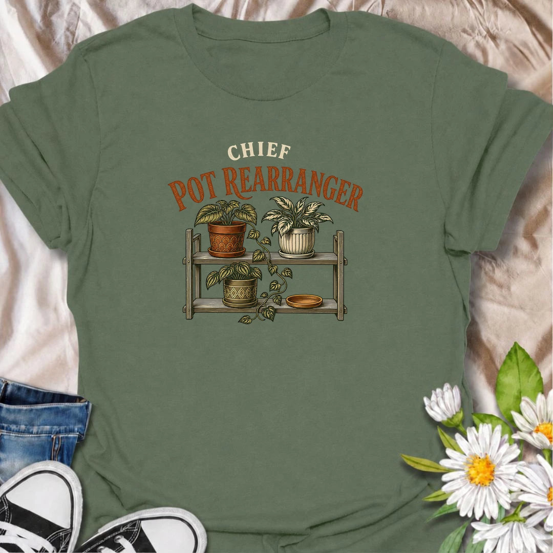 A funny houseplant T-shirt for anyone who can never leave the pots where they are for very long. Featuring a vintage-style plant shelf with patterned pots and trailing greenery, this design is perfect for plant parents who are constantly shifting, styling, and reorganizing their collection. The phrase “Chief Pot Rearranger” captures the familiar habit of moving plants around until everything feels just right. It makes a great gift for houseplant lovers, indoor gardeners, and anyone who treats plant shelves 