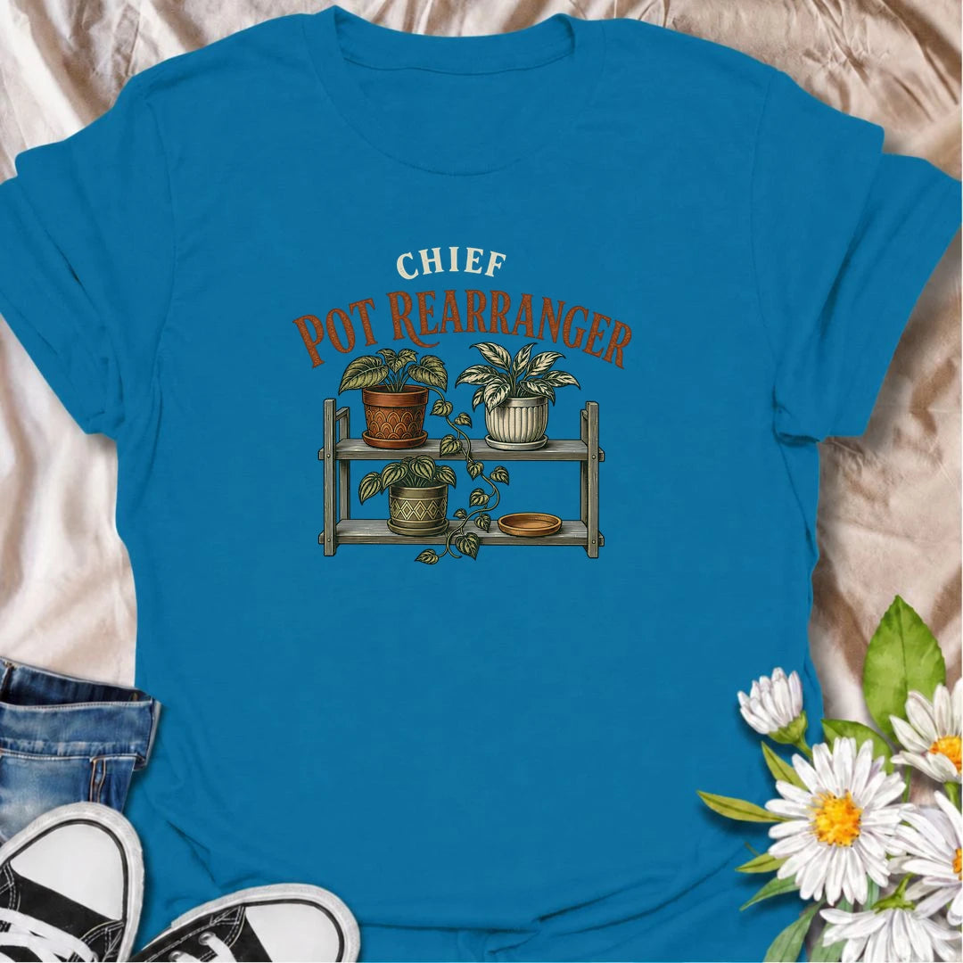 A funny houseplant T-shirt for anyone who can never leave the pots where they are for very long. Featuring a vintage-style plant shelf with patterned pots and trailing greenery, this design is perfect for plant parents who are constantly shifting, styling, and reorganizing their collection. The phrase “Chief Pot Rearranger” captures the familiar habit of moving plants around until everything feels just right. It makes a great gift for houseplant lovers, indoor gardeners, and anyone who treats plant shelves 