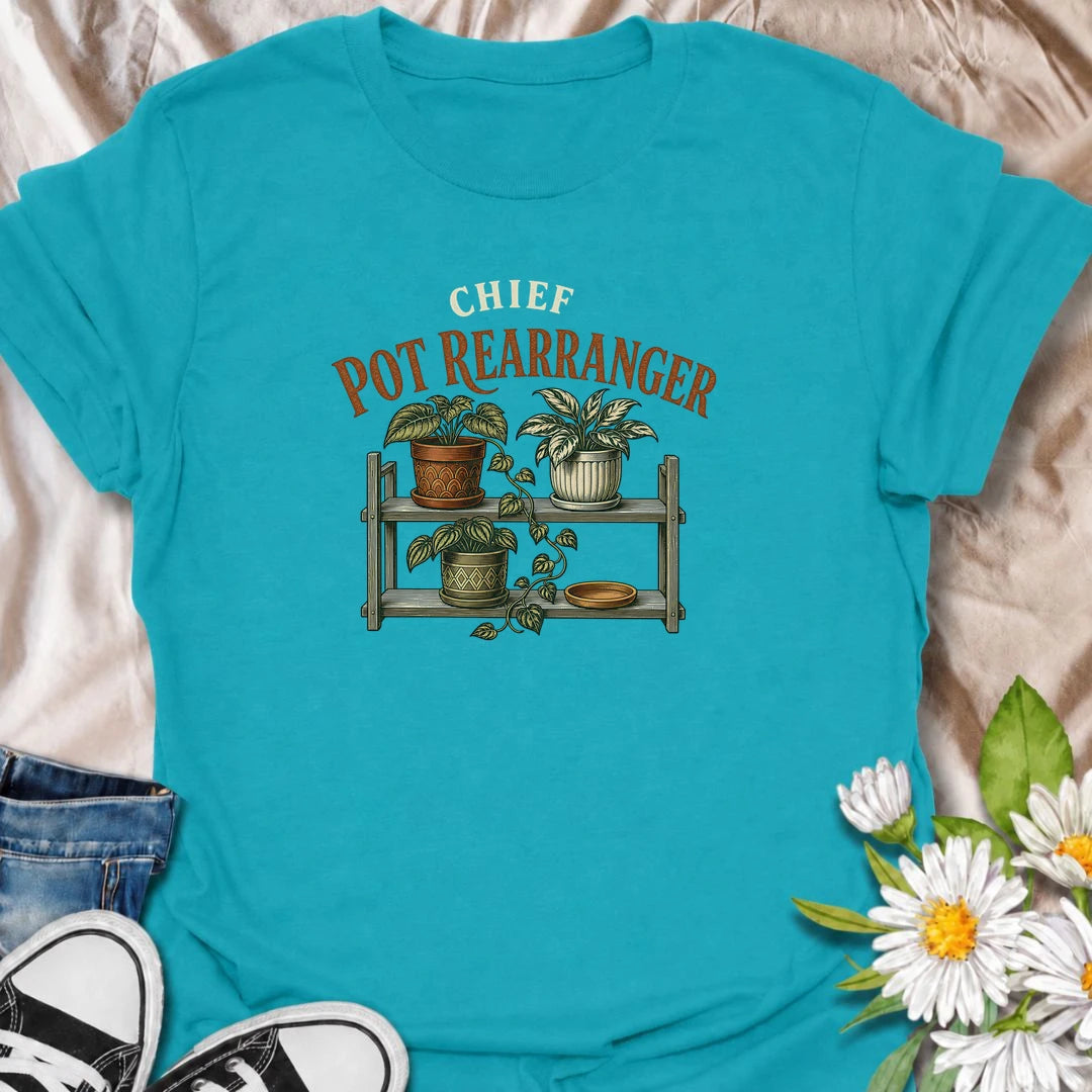 A funny houseplant T-shirt for anyone who can never leave the pots where they are for very long. Featuring a vintage-style plant shelf with patterned pots and trailing greenery, this design is perfect for plant parents who are constantly shifting, styling, and reorganizing their collection. The phrase “Chief Pot Rearranger” captures the familiar habit of moving plants around until everything feels just right. It makes a great gift for houseplant lovers, indoor gardeners, and anyone who treats plant shelves 