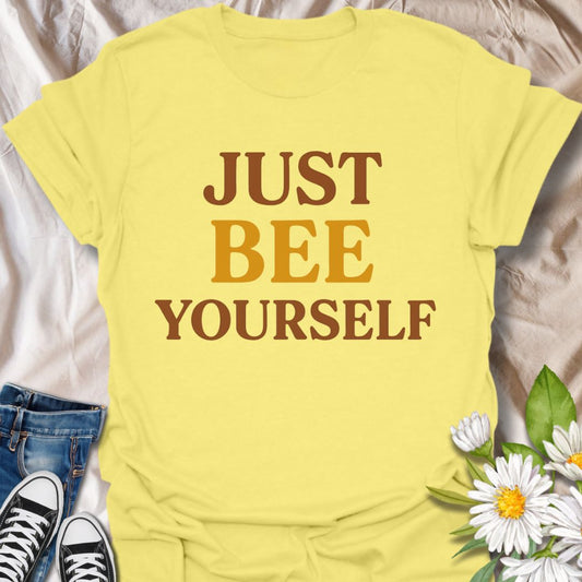 Stay positive and authentic with this playful graphic t-shirt featuring the uplifting phrase "Just Bee Yourself." Perfect for bee lovers, nature enthusiasts, and anyone who enjoys motivational apparel with a touch of humor and charm.