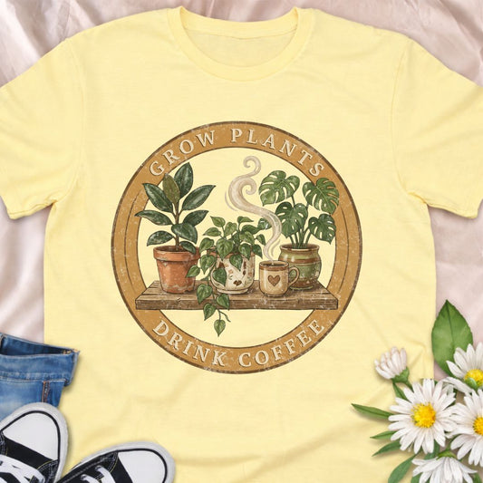 Celebrate slow mornings in the garden with this cozy “Grow Plants, Drink Coffee” t-shirt, featuring a vintage-style badge with houseplants and steaming coffee mugs. Perfect for plant moms, plant dads and caffeine-fueled gardeners, this soft graphic tee makes a thoughtful gift for houseplant lovers, coffee addicts and anyone who finds peace in watering plants with a mug in hand.