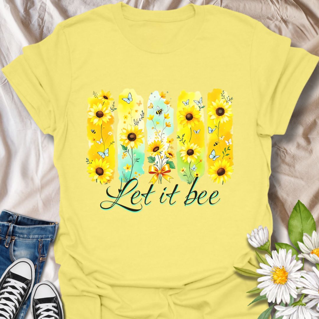 Bright sunflower t-shirt with bees and butterflies and the playful phrase "Let it bee." Perfect for nature lovers, bee enthusiasts, gardeners, and wildflower fans who appreciate pollinators. Fun spring and summer tee celebrating positivity and nature’s beauty. Cornsilk