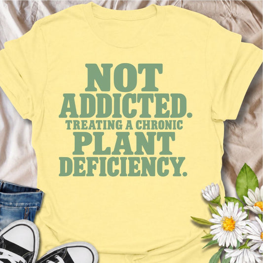 A funny plant T-shirt for anyone who insists their growing collection is not an addiction—it is clearly a plant deficiency. The phrase “Not Addicted. Treating a Chronic Plant Deficiency.” delivers dry, self-aware humor that plant parents and houseplant collectors will instantly understand. Its bold retro typography keeps the design simple, readable, and easy to wear. It makes a great gift for plant lovers, nursery regulars, and anyone whose answer to almost everything is another plant. Perfect for plant swa