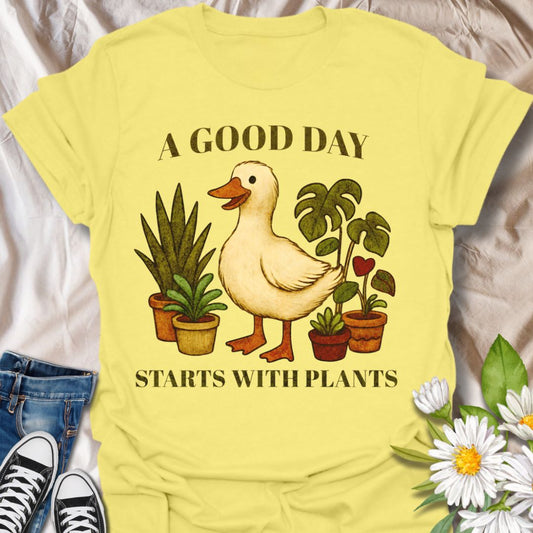 Brighten your wardrobe with this charming goose and houseplants graphic t-shirt featuring the phrase "A Good Day Starts With Plants." Perfect for plant parents, gardeners, animal lovers, and anyone who enjoys cute and quirky botanical-themed apparel.