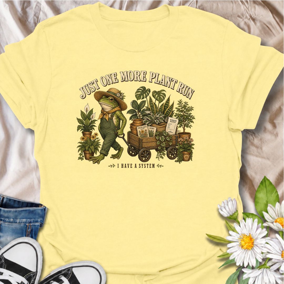 A funny plant-shopping T-shirt featuring a stylish frog and a wagon full of nursery finds. Made for plant lovers who can never buy just one more.