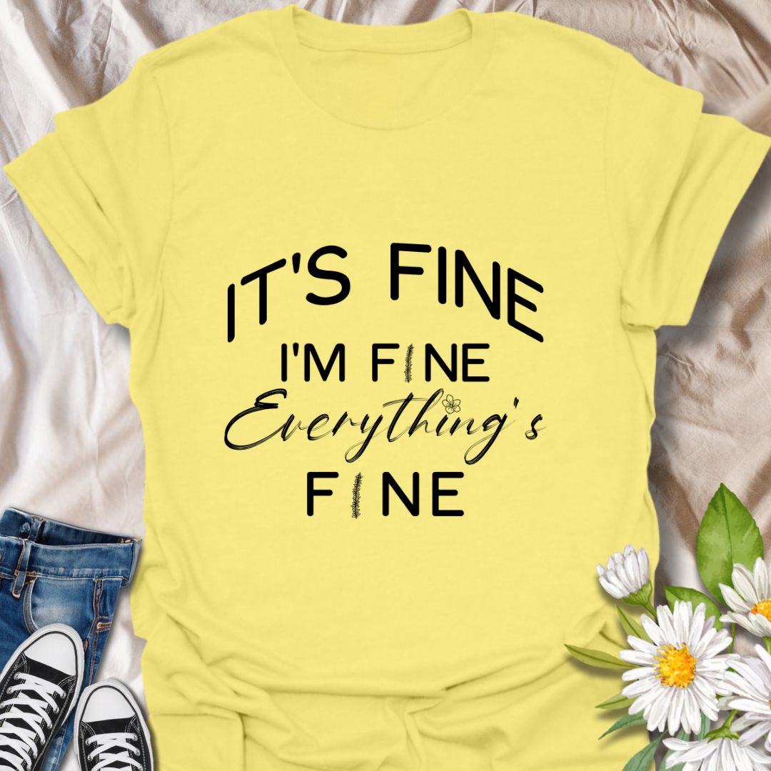 Keep it together (barely) with this humorous “It’s Fine. I’m Fine. Everything’s Fine” t-shirt. A relatable design with playful typography and a subtle floral touch—perfect for those who handle chaos with a smile.