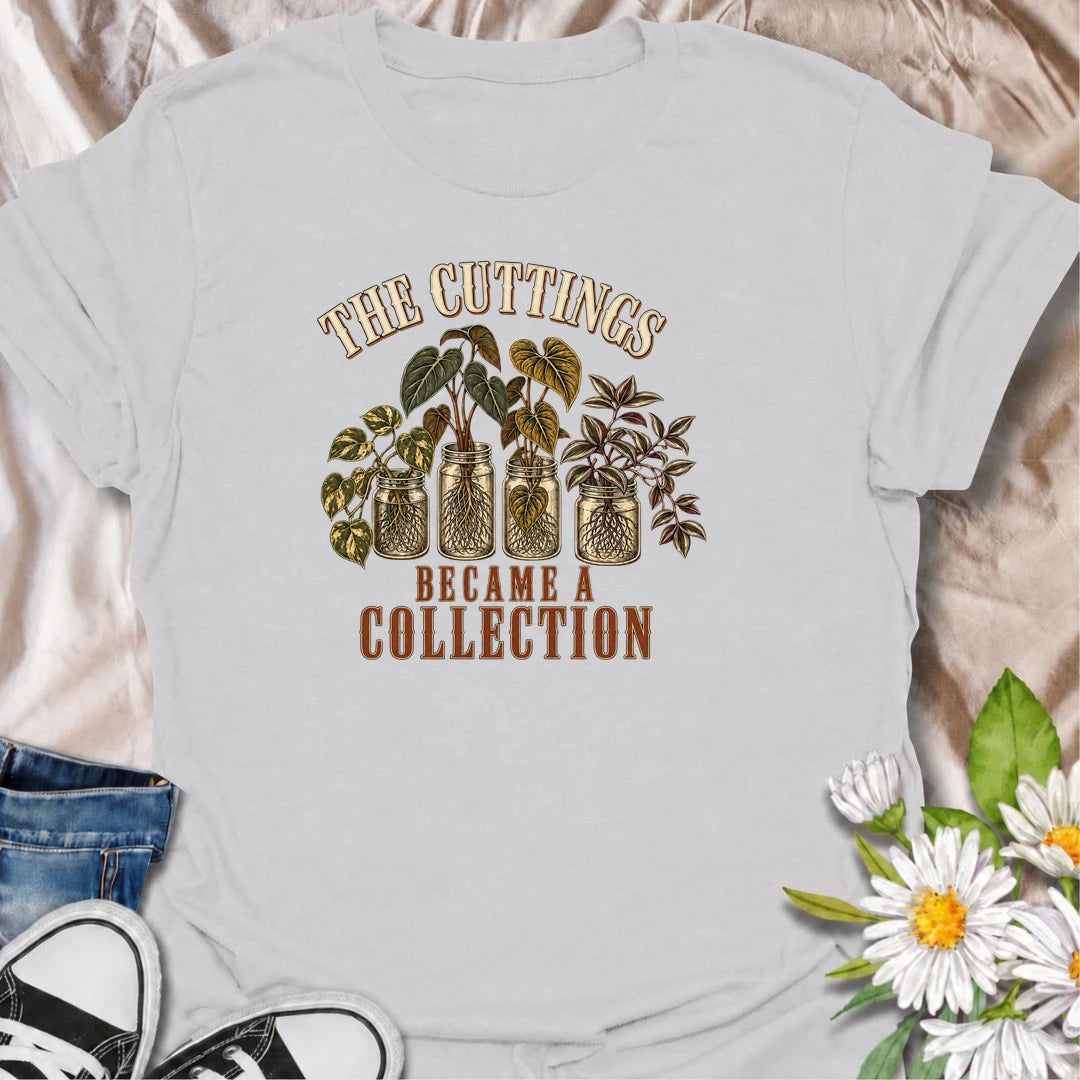 A funny propagation T-shirt for plant lovers who started with one cutting and somehow ended up with an entire collection. Featuring rooted houseplant cuttings growing in glass jars, this design is perfect for propagation fans, plant parents, and indoor gardeners. The phrase “The Cuttings Became a Collection” captures that very familiar moment when a simple hobby turns into another shelf full of plants. It makes a great gift for pothos lovers, monstera fans, and anyone who is always saving, swapping, or root