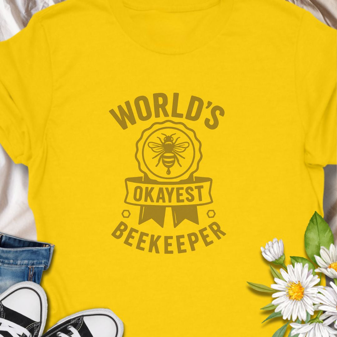 Celebrate your love for beekeeping with a humorous twist in this "World's Okayest Beekeeper" T-Shirt. Perfect for backyard beekeepers, honey lovers, and bee enthusiasts who know it's not about perfection—it's about passion. Makes a great gift for bee dads, moms, hobbyists, and anyone who keeps buzzing through life.