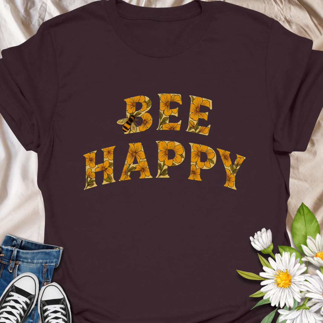 Spread positivity and nature-loving vibes with this charming “Bee Happy” t-shirt, featuring sunflower-filled typography and a playful bee motif. Perfect for beekeepers, garden lovers, and anyone who appreciates cheerful, nature-inspired fashion. A great gift for pollinator advocates and flower enthusiasts.