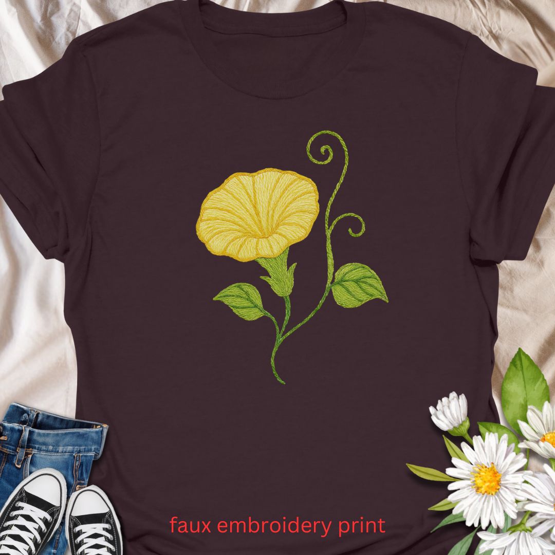 Add a touch of garden charm to your outfit with this faux embroidery t-shirt featuring a delicate yellow morning glory flower. Designed with a stitched-look finish, this nature-inspired tee is perfect for plant lovers, gardeners, and fans of floral simplicity. A soft, botanical vibe for everyday wear or gifting.