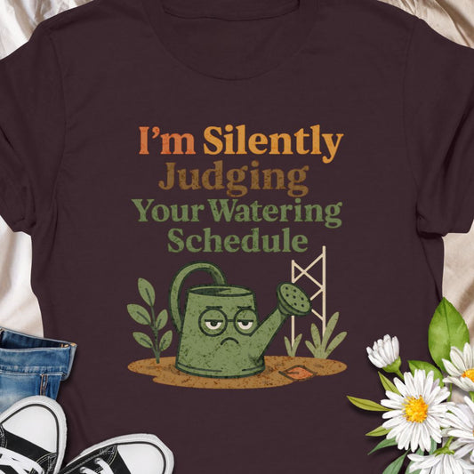 Show off your plant-parent sass with this “I’m Silently Judging Your Watering Schedule” tee featuring a grumpy watering can. A hilarious gift for  moms, dads who enjoy their gardens, and anyone with a love for keeping their leafy friends happy. Ideal for houseplant lovers and garden geeks alike.