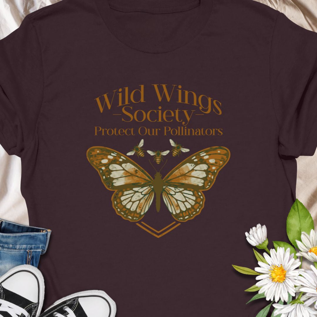 Butterfly conservation themed shirt with 'Wild Wings Society' design. Great for nature lovers and pollinator protectors.   Soft, worn-in comfort meets quiet activism - a warm-toned monarch rests at the center of a vintage-inspired crest, with the words “Wild Wings Society — Protect Our Pollinators” arched above. 
