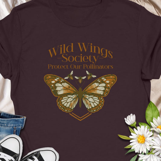 Butterfly conservation themed shirt with 'Wild Wings Society' design. Great for nature lovers and pollinator protectors.   Soft, worn-in comfort meets quiet activism - a warm-toned monarch rests at the center of a vintage-inspired crest, with the words “Wild Wings Society — Protect Our Pollinators” arched above. 